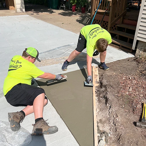 Workers laying out the concrete for the driveway of a home in Twin Cities.